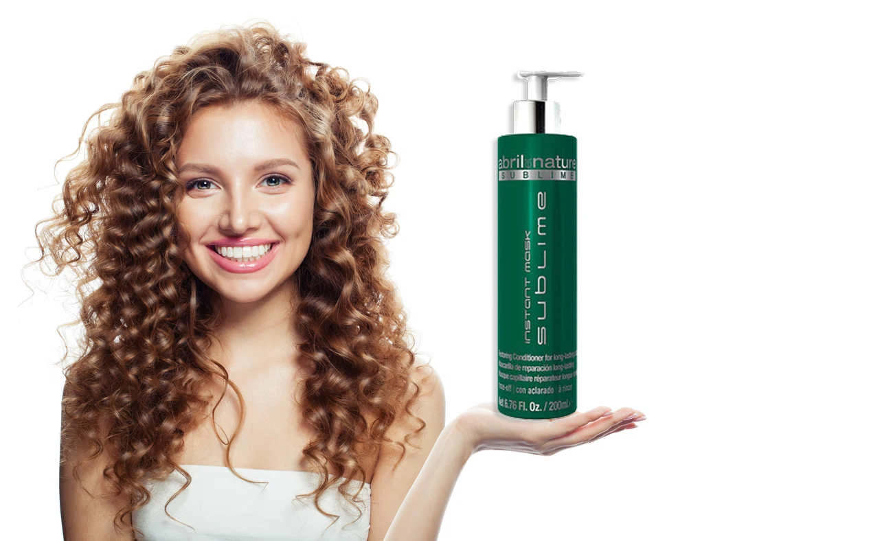 Young lady is holding caviar hair treatment which is Sublime Mask