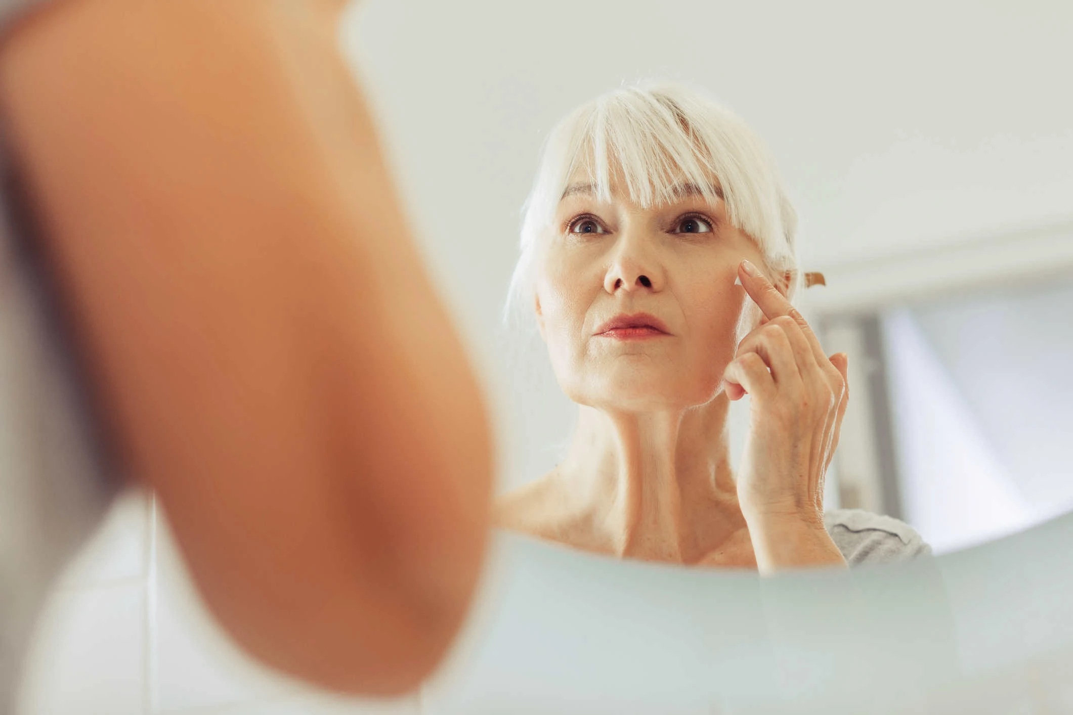 Old woman with signs of aging - wrinkles