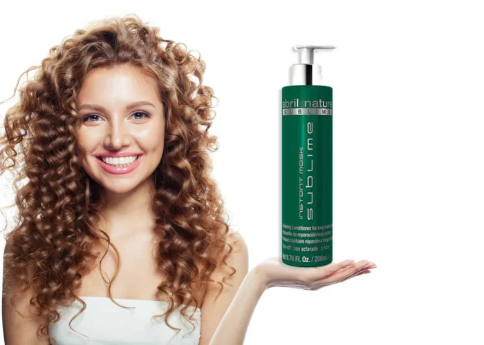 Young lady is holding caviar hair treatment which is Sublime Mask