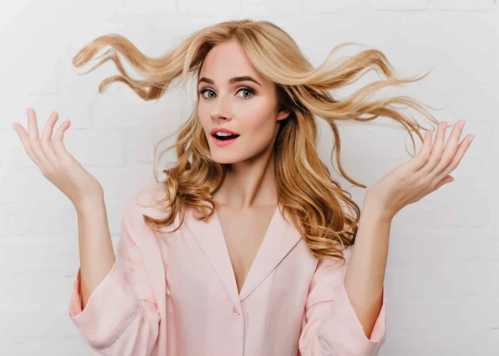 Young blonde lady is thinking How to Grow Hair Faster