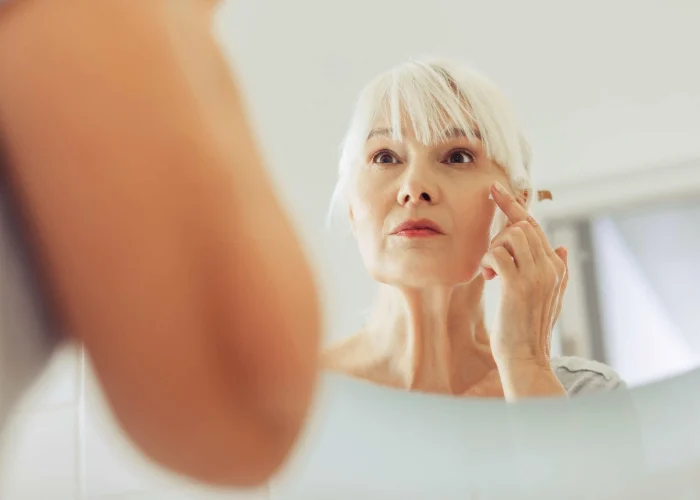 Old woman with signs of aging - wrinkles